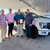 Wagner award presentation beside a white Ford truck