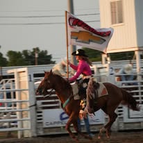 Rodeo rider carrying a Wagner flag